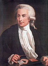 Painting of a middle-aged man sitting by the table, wearing a wig, black jacket, white shirt and white scarf.