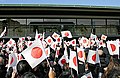 Emperor Akihito prepares to greet the crowd on his birthday