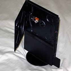 Slim Version PlayStation 2 mounted on base stand.