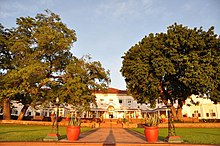 A large, white colonial-style hotel