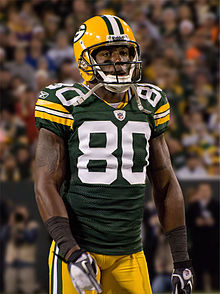 Driver standing on a field in uniform during a game