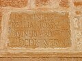 Close view of one of the Roman stones (with Latin inscriptions) reused at the base of the minaret