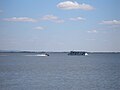 Tour boat and jetskis on Zemplínska Šírava near Klokočov during the summer season