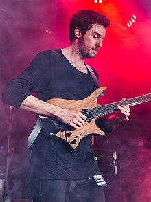 Plini playing guitar onstage