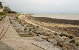 The coast of Saint-Jean-le-Thomas with views of Mont Saint-Michel and the rock of Tombelaine in the evening mist