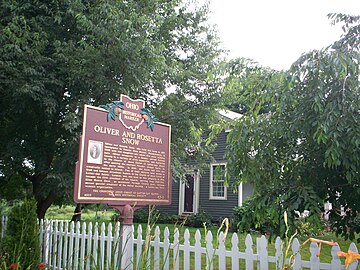 Historic marker with Snow house in the background, 2009. The house was built in 1815