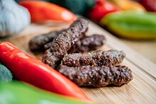 Closeup grilled Serbian sausages (49152328346).jpg