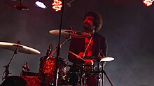 Moretti performing with the Strokes in 2019