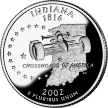 A coin with a racecar and the slogan "Crossroads of America" on it