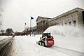 Skid loader clearing snow with snowblower attachment in Minneapolis, MN