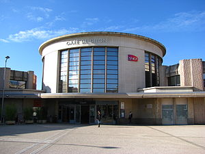 Circular glass-enclosed tower above flat, single-story building