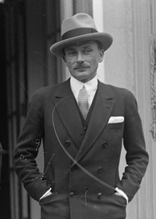 Photograph of Lucien Lelong wearing a suit and hat