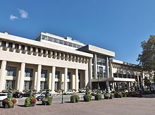 Photographie en couleurs d'un long bâtiment style XIXe siècle.