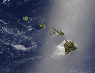 A satellite view of the Hawaiian islands, with the top of the image being North. There are few if any clouds, and most of the image is the seawater swirling in the wind, surrounding the islands.