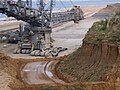 Policemen in front on the giant coal excavator