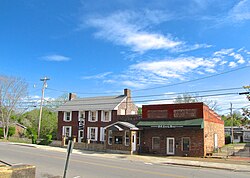 The Drug Store (left) and Polk County News block in Benton