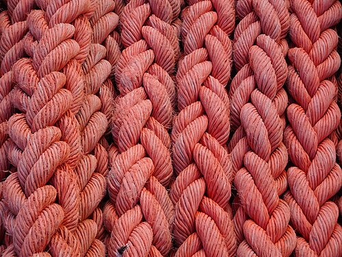 Coil of orange rope onboard of ORP Kraków, Świnoujście, Poland