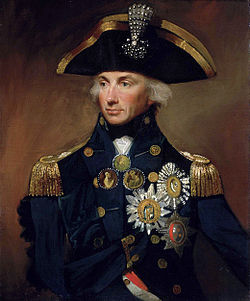 Portrait of a man in an ornate naval uniform festooned with medals and awards.