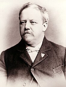 Black and white picture of James Henry Carpenter, a white male with a GAR pin on lapel circa 1895.