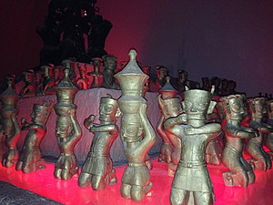 Bronze figurines wearing belted tunics, Sanxingdui