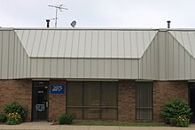 A nondescript office suite in a one-story building. The only clue WPXD used it is the sign reading W P X D TV near the front door.