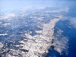 Aerial view of Ōmu (at bottom edge of picture) with Esashi in the distance