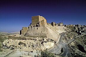 A castle built of stones on a cliff near a settlements