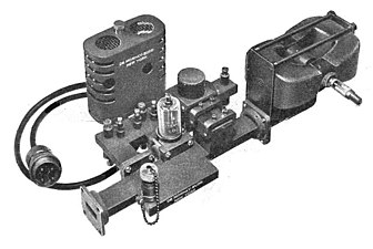 Transmitter assembly of a 20 kW, 9.375 GHz air traffic control radar, 1947. The magnetron tube mounted between two magnets (right) produces microwaves which pass from the aperture (left) into a waveguide which conducts them to the dish antenna.