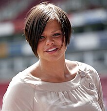 A dark haired woman smiling