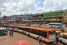 Photograph of bus station, including vehicles and buildings