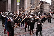 First rank holding pikes at charge for combat and second rank holding pikes at port to avoid injuring front rank soldiers while waiting to replace them (in real combat first 3–5 ranks would hold their pikes at charge, depending on the formation density and pole length, so as all the charged pikes would have their points in front, not inside the formation)