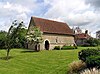 A simple flint church with a red tiled roof