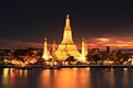 Image 23Wat Arun, the most prominent temple of the Thonburi period, derives its name from the Hindu god Aruṇa. Its main prang was constructed later in the Rattanakosin period. (from History of Thailand)