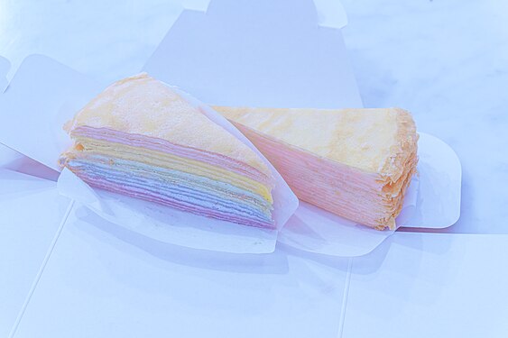 A piece of pastel colors rainbow mille crepe cake and A piece of strawberry cream mille crepe cake