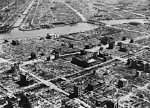 A vast devastated area with only a few burned out buildings standing