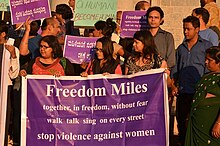 People carrying a banner marching in a protest against gang rape