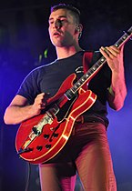 Man playing a guitar on stage