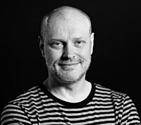 A black and white headshot of a man