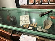 Cabinet at the Crozer Schoolhouse displaying artifacts from the Caleb Pusey House