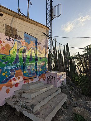 One of two small, graffiti-covered buildings on top of Hooiberg.