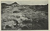 Black-and-white photograph of a tomb being excavated.