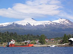 Puerto Fui and its ferry at Pirihueico Lake. Mocho-Choshuenco Volcano in the background.