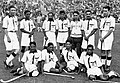 Indian hockey team, captained by Dhyan Chand (standing second from left), after winning the finals at the 1936 Summer Olympics – their third of six consecutive Olympic golds.[citation needed]