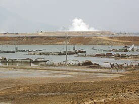 Image shows scale of the mud hole, with efforts to contain it by removing the mud and creating embankments for flood defence.