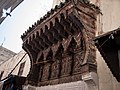 The ornately-carved wooden canopy above the mosque's entrance (present day)