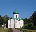 A white orthodox church with a green roof