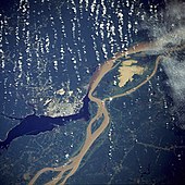 Manaus, the largest city on the Amazon River, from a NASA satellite image, surrounded by the muddy Amazon River and the blackwater Rio Negro