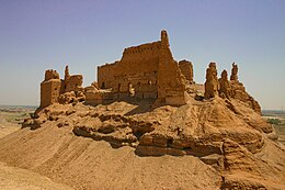 A weathered fortress capping a hill.