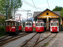 Five trams in front of a two-track tram shed