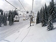 Skiers riding a chairlift